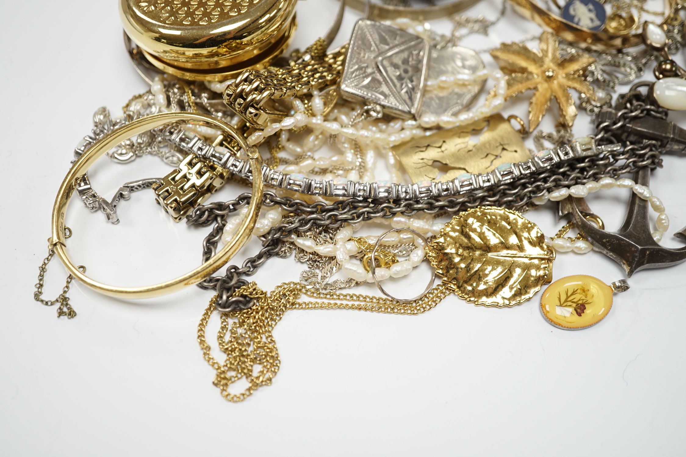 A quantity of assorted costume and silver jewellery including pendants, locket, bracelets, bangles, chains etc.